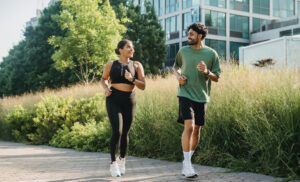 Kurs zdrowy styl życia. Kobieta i mężczyzna biegają na drodze.